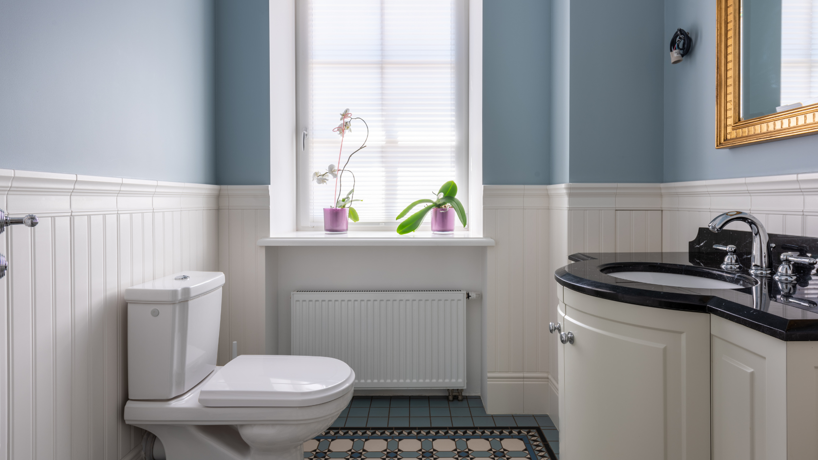 A white toilet sitting next to a window in a bathroom