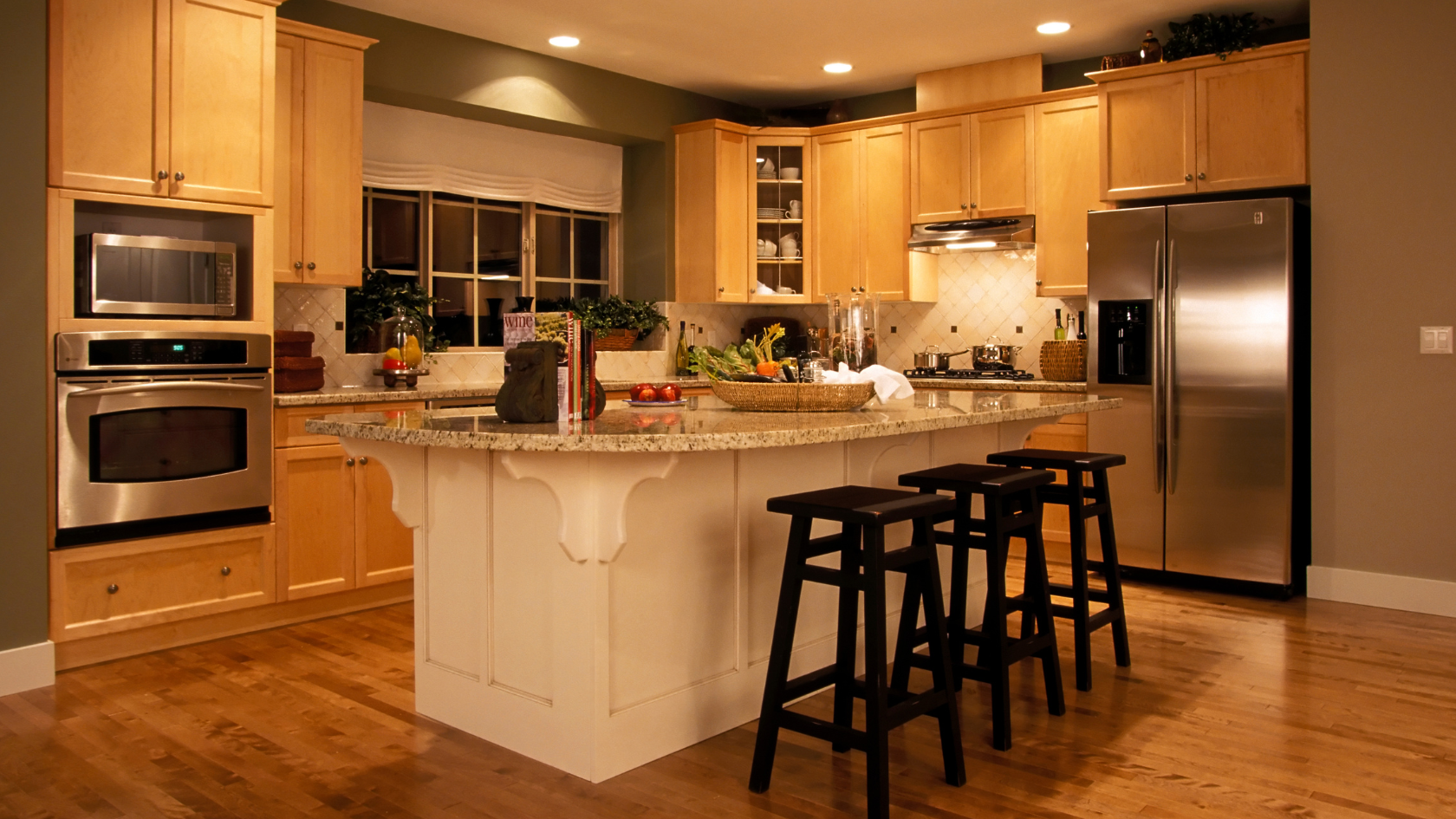 A kitchen with a center island with stools